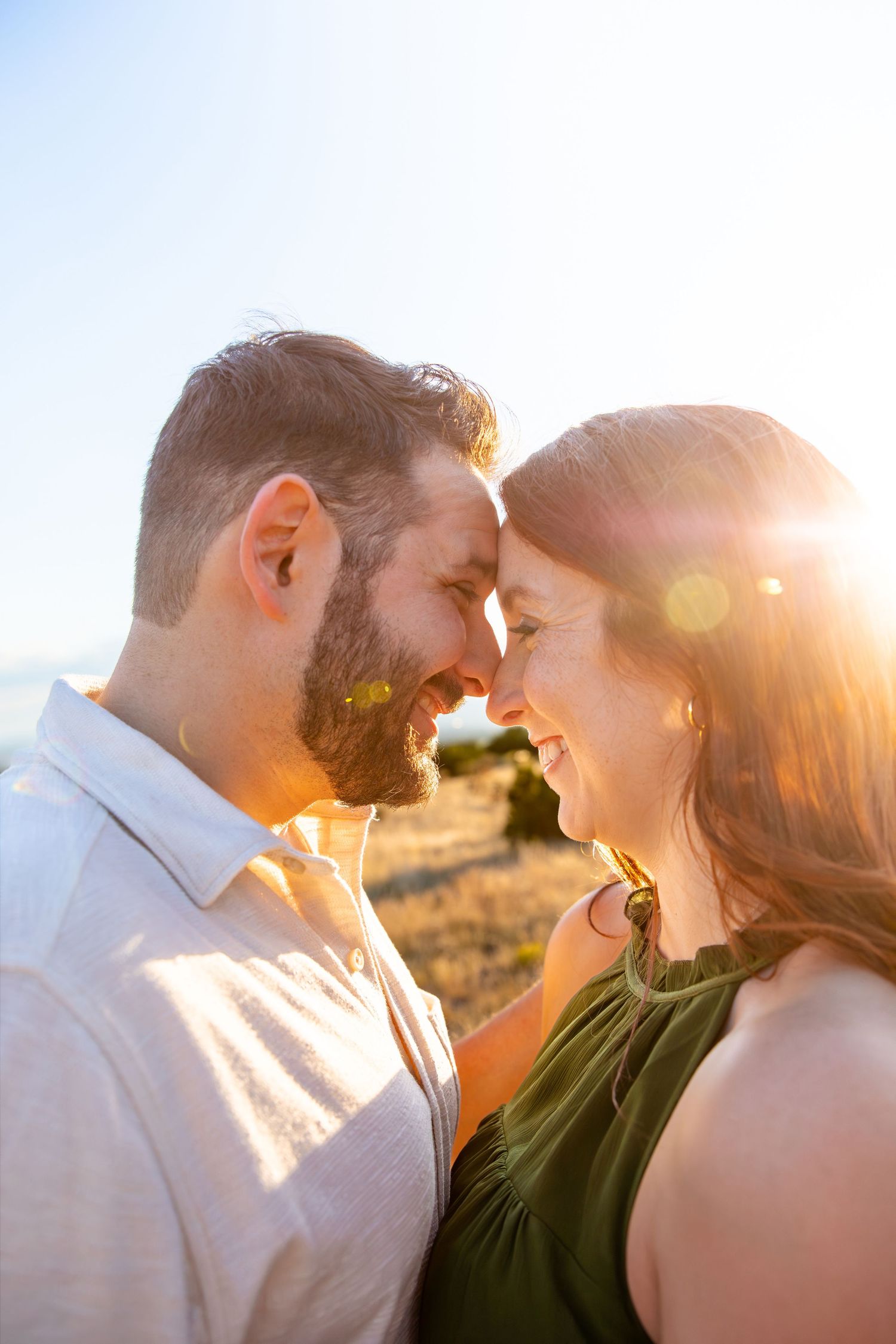 A couple wearing matching black tops pose together. Shot by Elle DeWeese Photography LLC in Albuquerque, New Mexico.