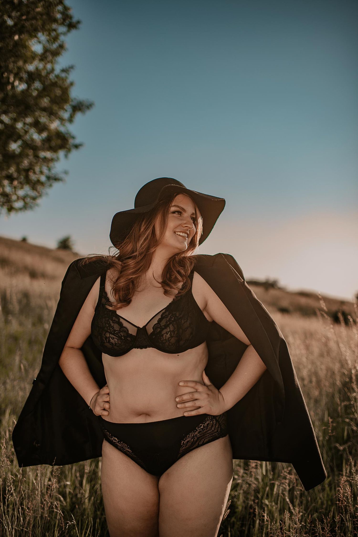 Artistic portrait in a wheat field with warm sunset lighting and vintage styling.
