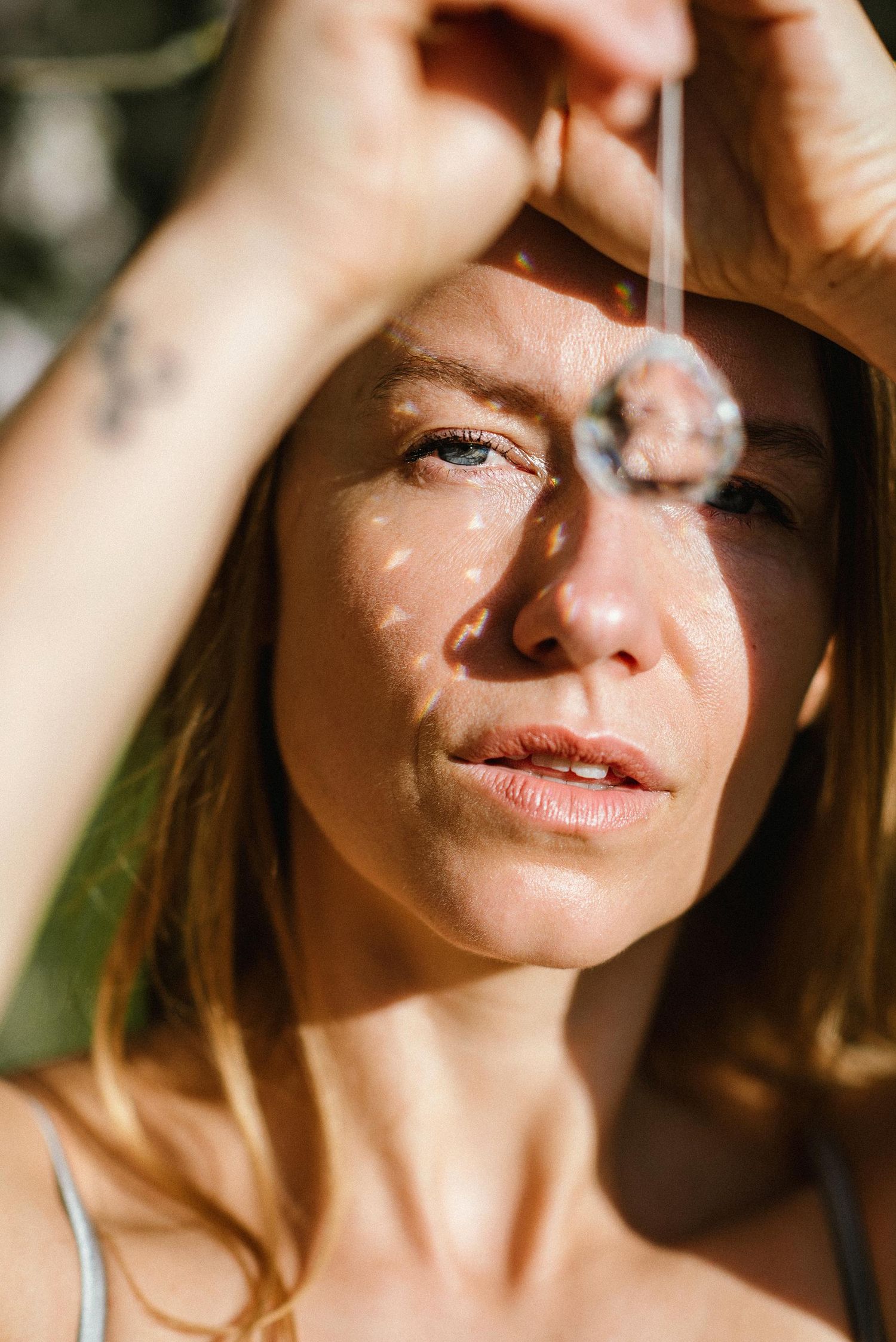 Close-up portrait with dramatic shadows and sunlight creating natural lighting patterns.