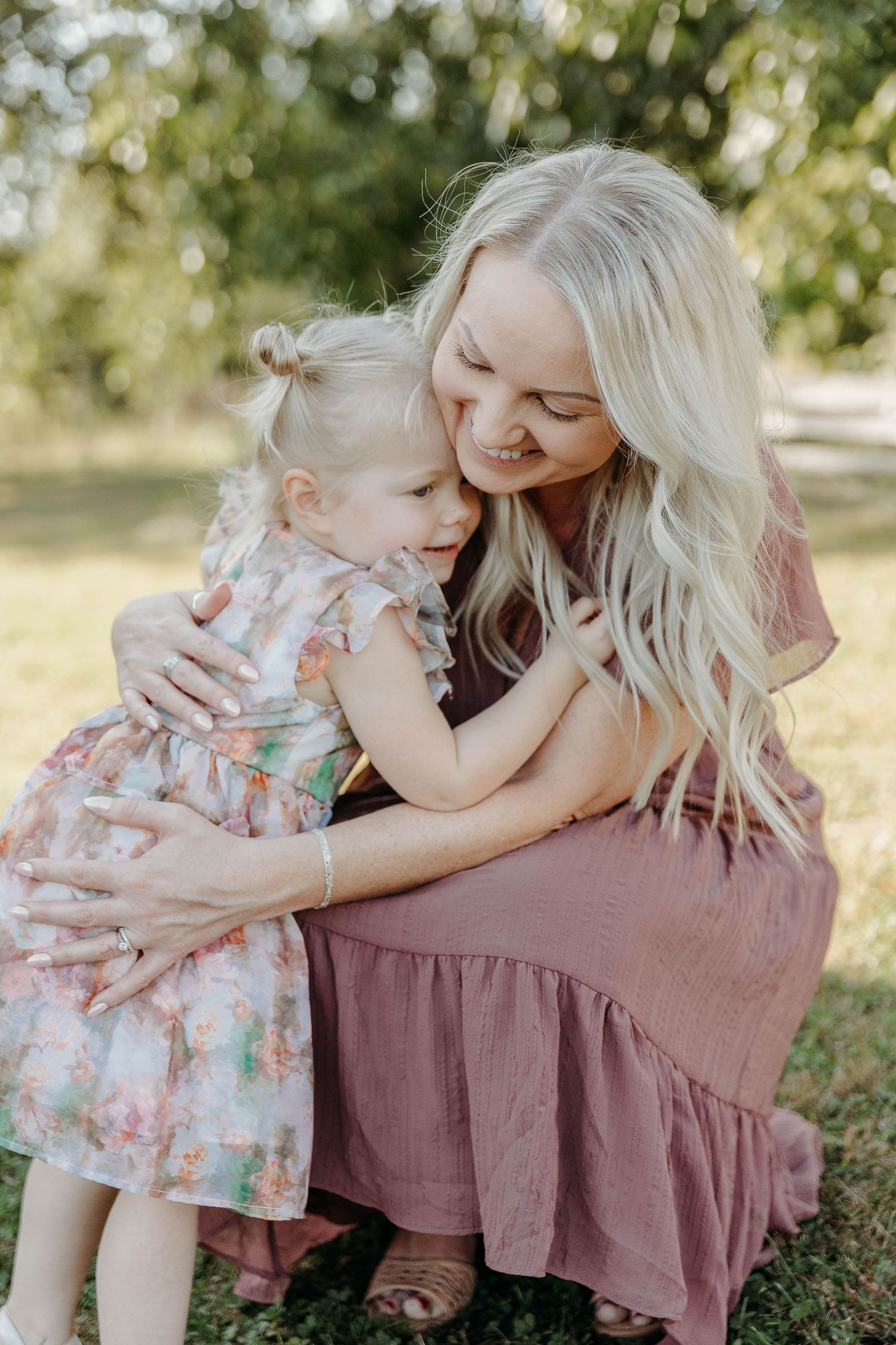 Sweet candid moments between parent and child sitting together outdoors in natural sunlight.