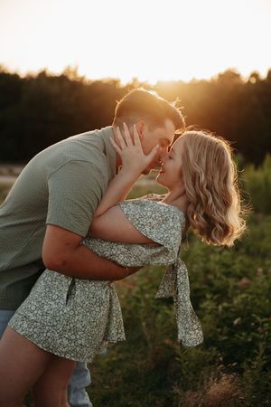 Intimate couple's portrait session captured during golden sunset in nature.