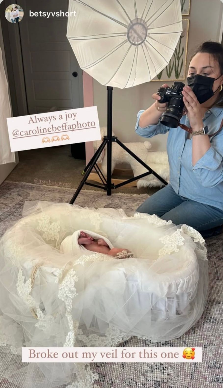 Newborn baby photographed in a white lace veil by photographer Caroline Beffa during a professional photo session.