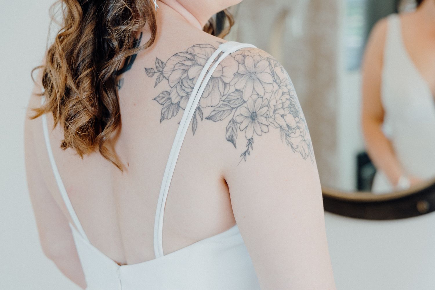 A detailed floral shoulder tattoo of the bride, captured by Apertured Media Auckland Wedding Photographer.