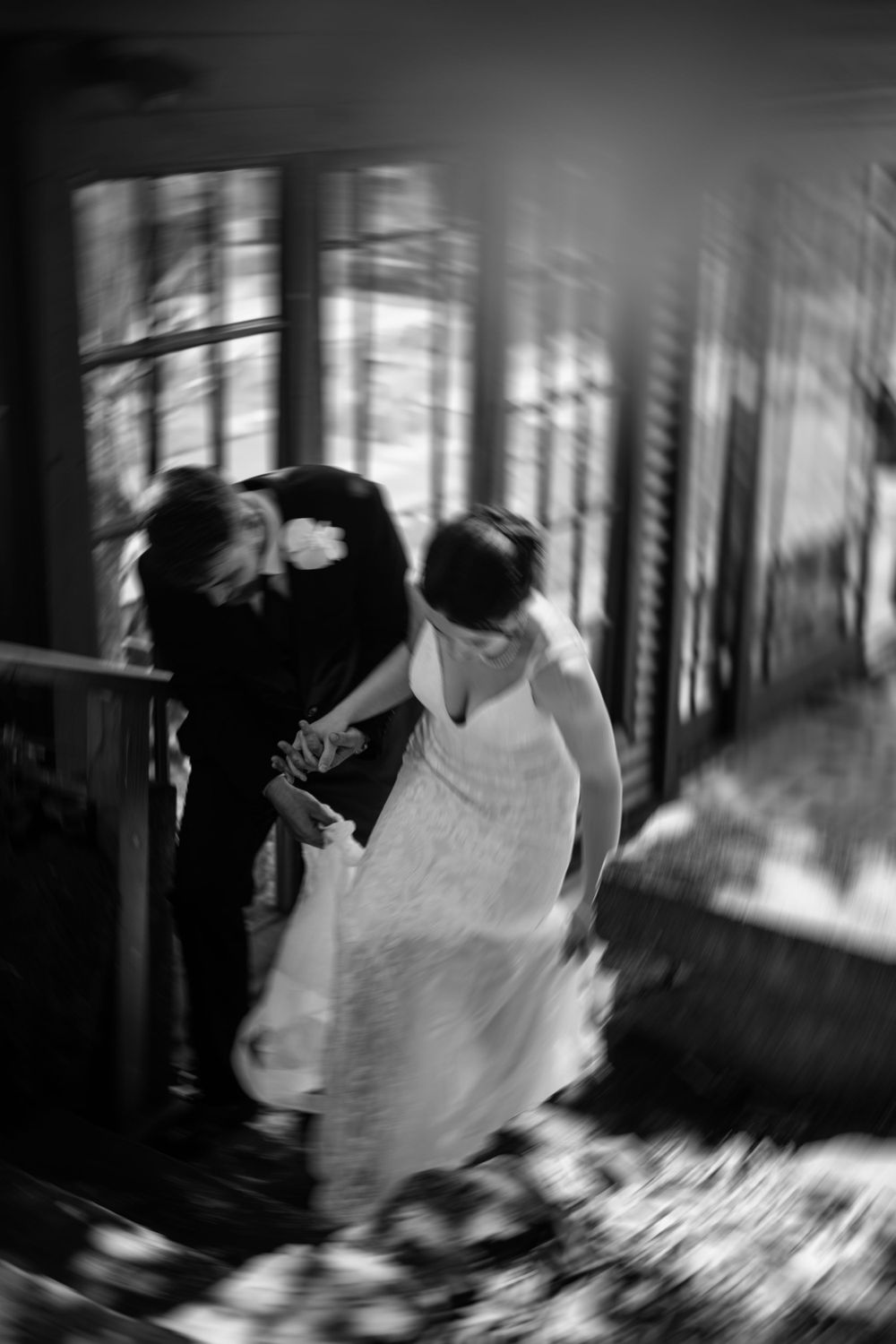 A series of artistic black and white motion blur photos capturing a flowing white dress in movement.