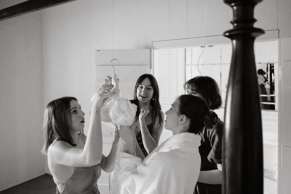 Bridesmaids getting ready in an elegant room during wedding preparations.