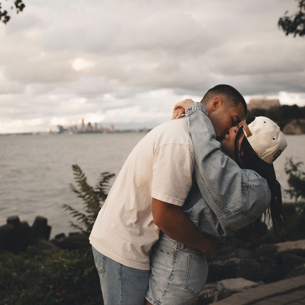 Candid couples session in Lakewood near Cleveland on Lake Erie. Playful, modern photography capturing real love and skyline views.