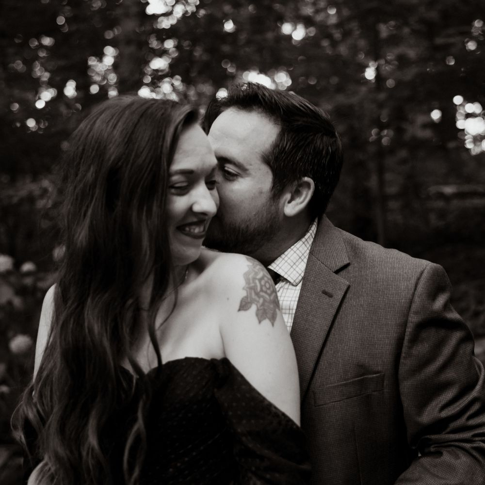 A cozy, candid engagement moment in the Cleveland Cultural Gardens — soft smiles, warm whispers, and love that feels effortlessly real.