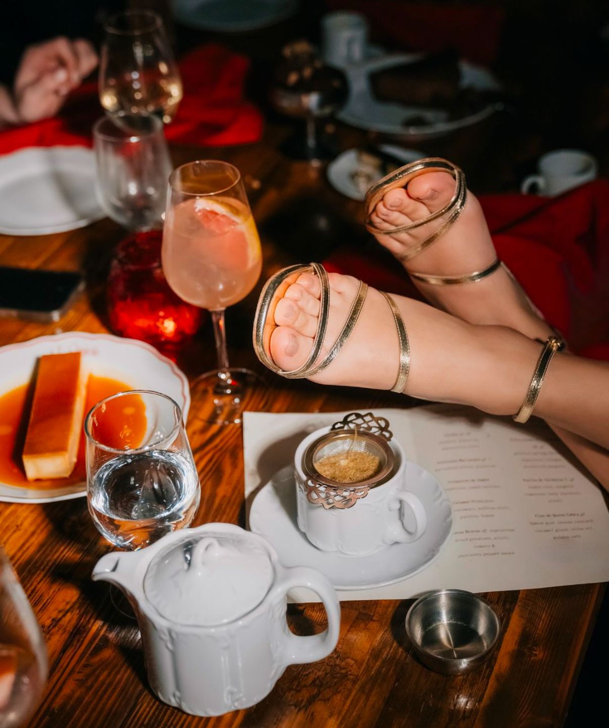 Coffee and cocktails on wooden table at romantic dinner setting.
