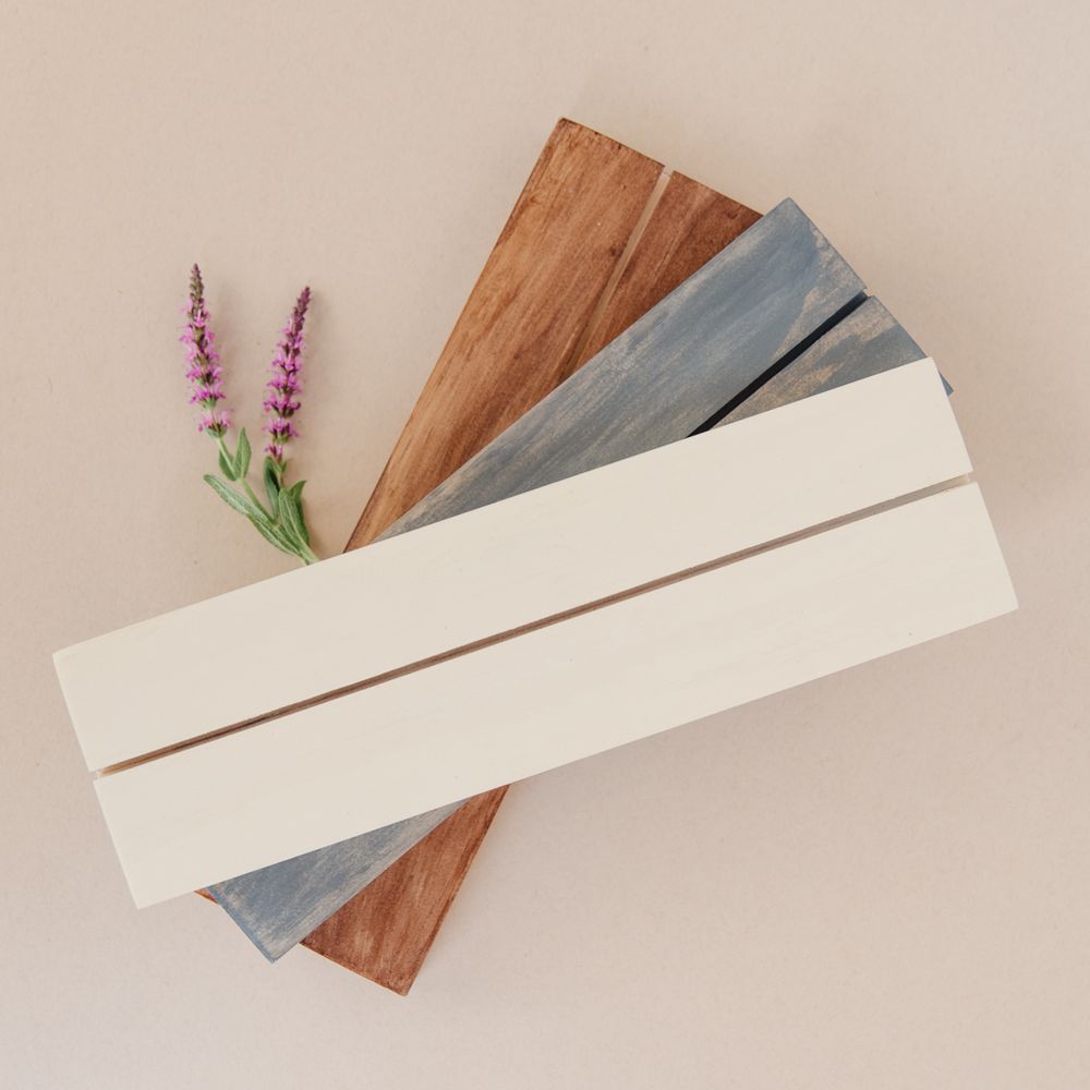 Wood plank samples in various finishes with purple flowers for decoration.