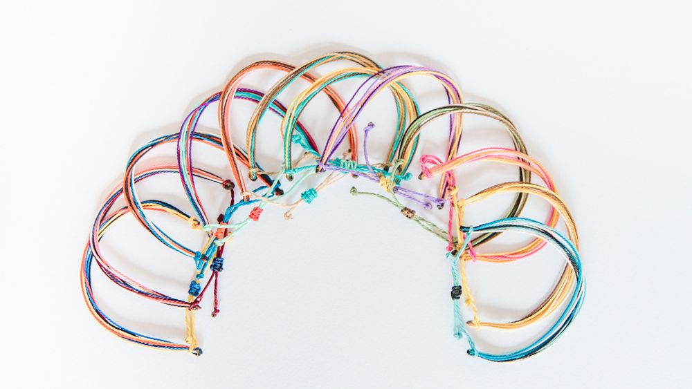 Multicolored headbands arranged in an arc pattern with turquoise beaded accents.