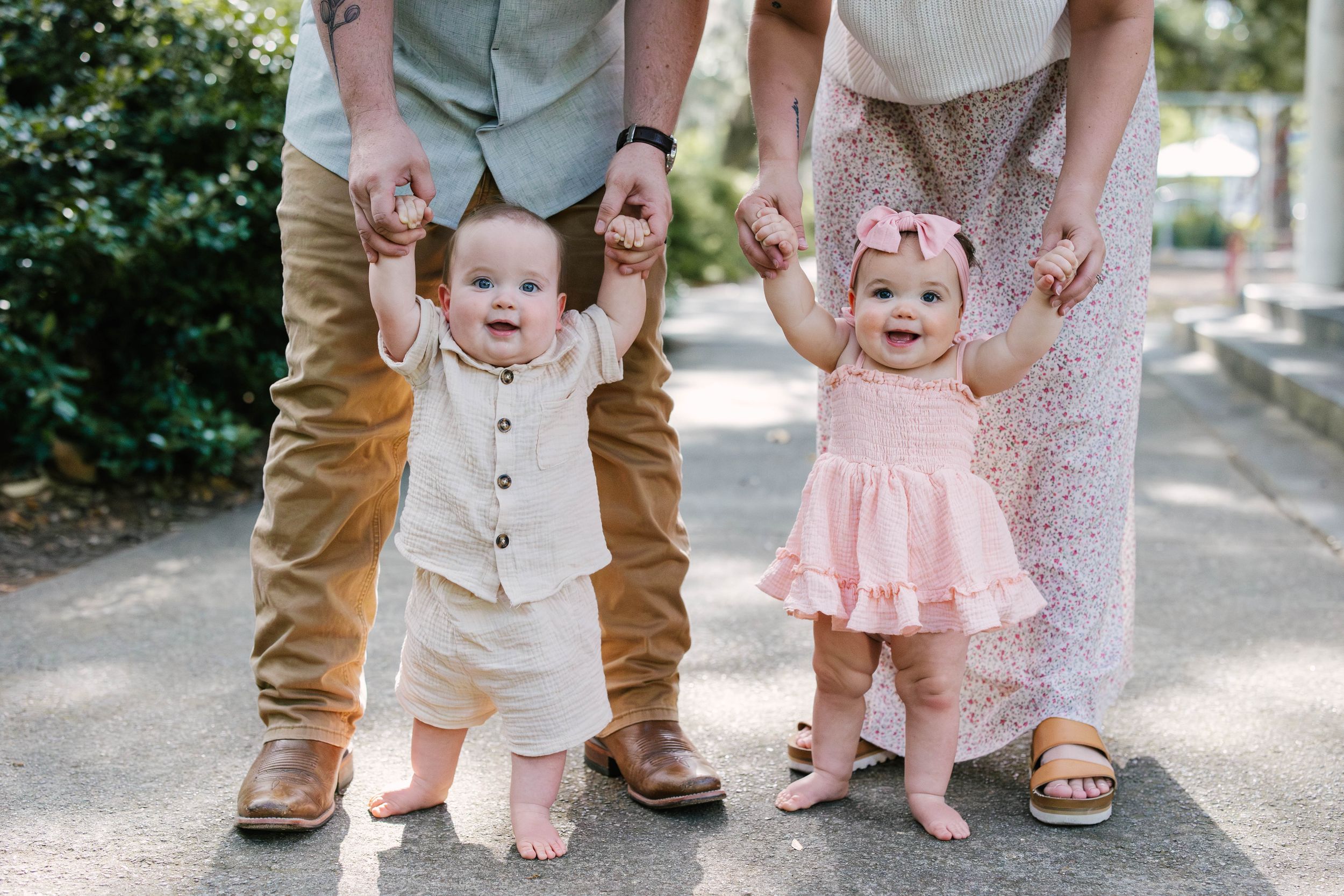 Close-up detail shots of feet and legs of family members standing together on a path outdoors.
