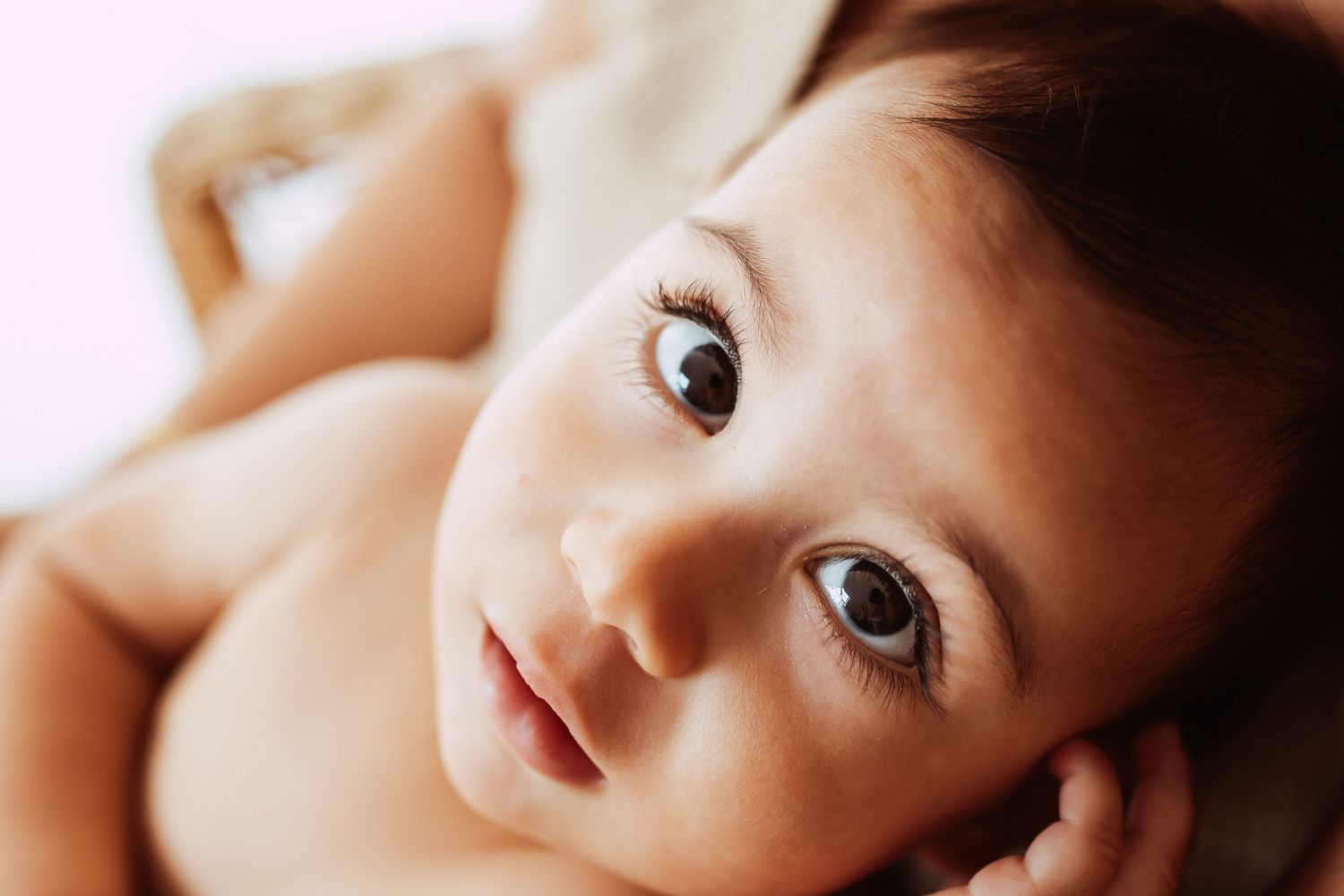 Close-up portrait of baby with soft lighting.