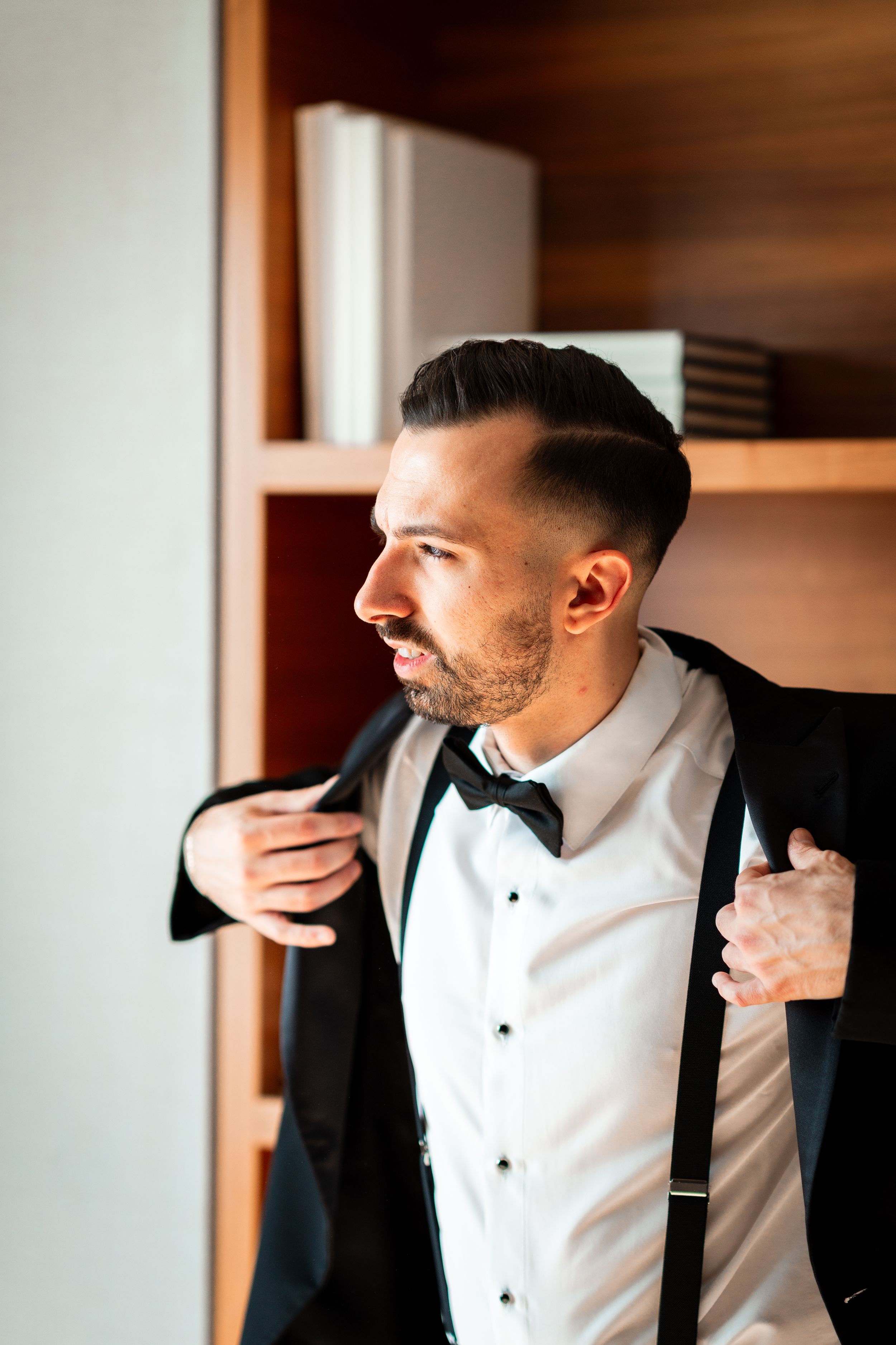 Close-up shots of formal attire adjustments showing crisp white shirt and black bow tie.