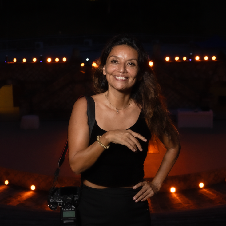 Professional headshot of someone wearing a black shirt against a blurred green background. Maxy Cory Photography