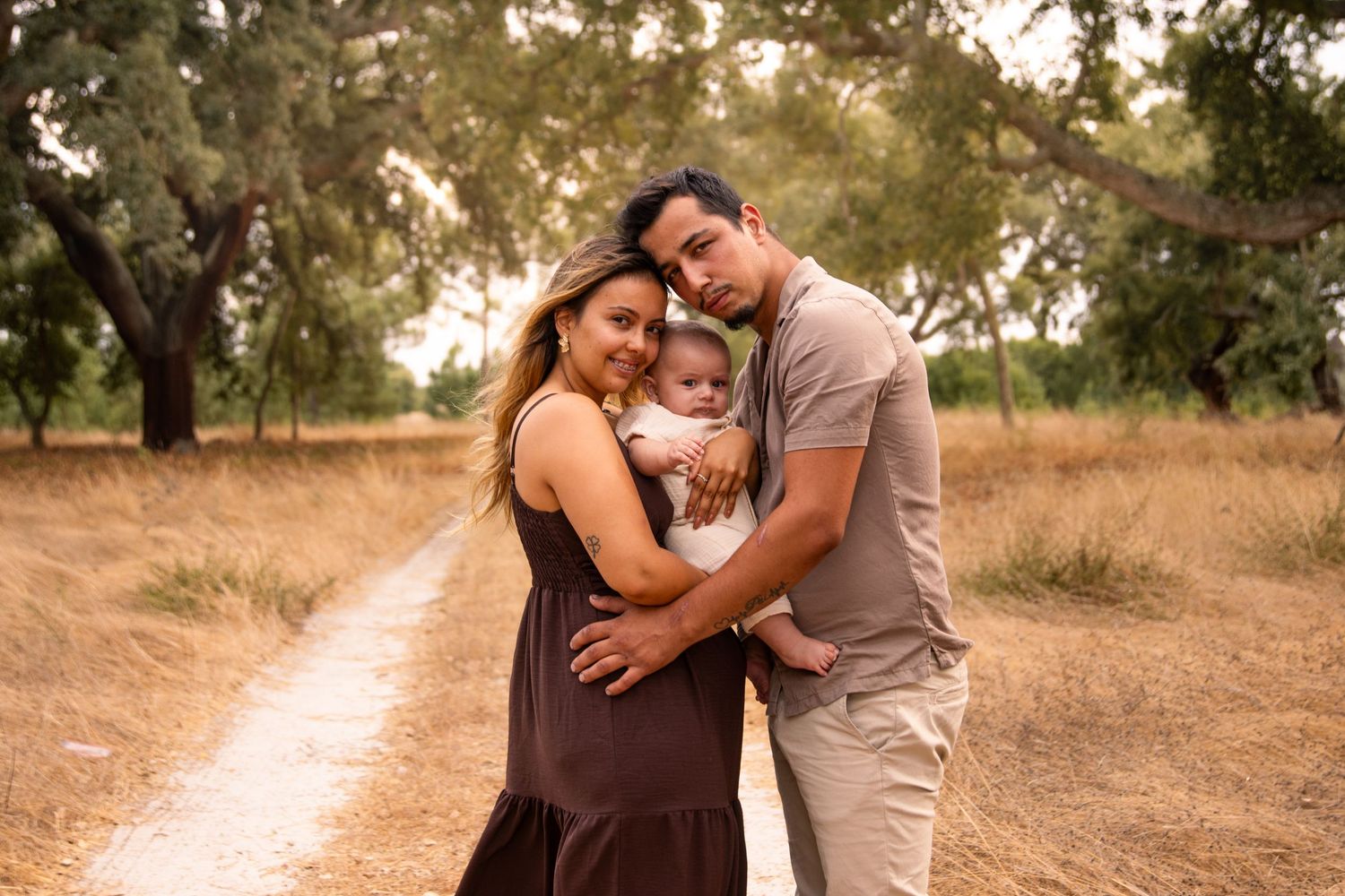Sweet family moments photographed in a rustic outdoor setting.