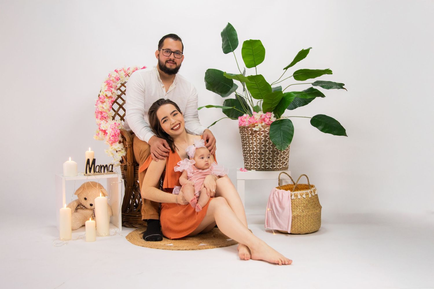 Intimate family moment captured on wooden platform with decorative elements.