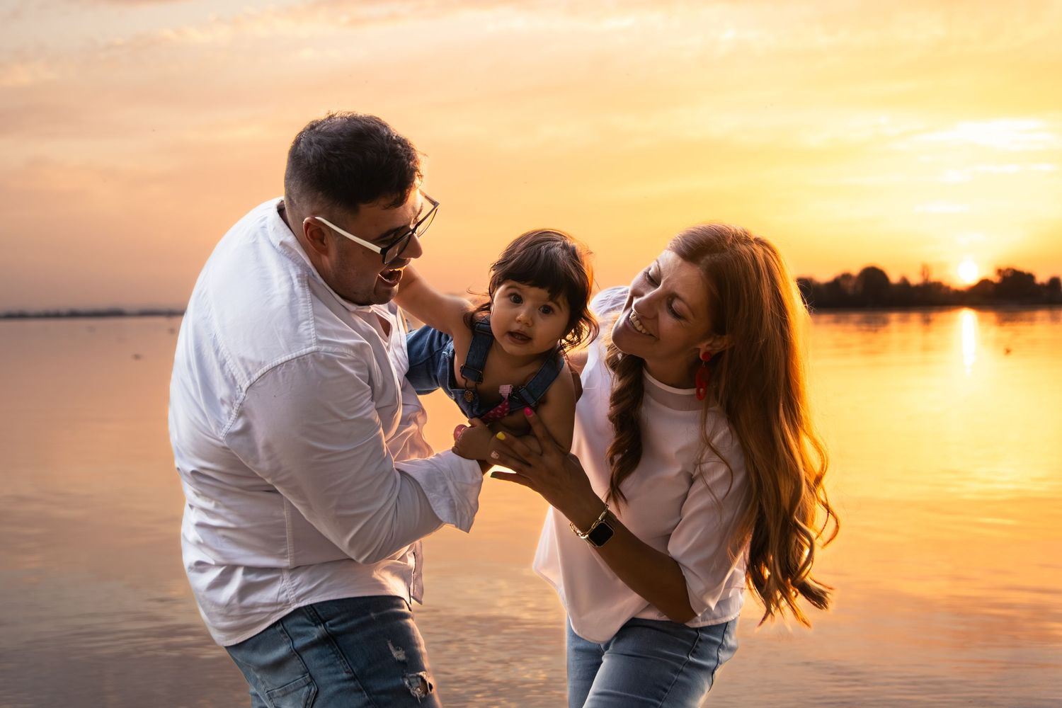 Candid family moments captured during golden hour at the beach.