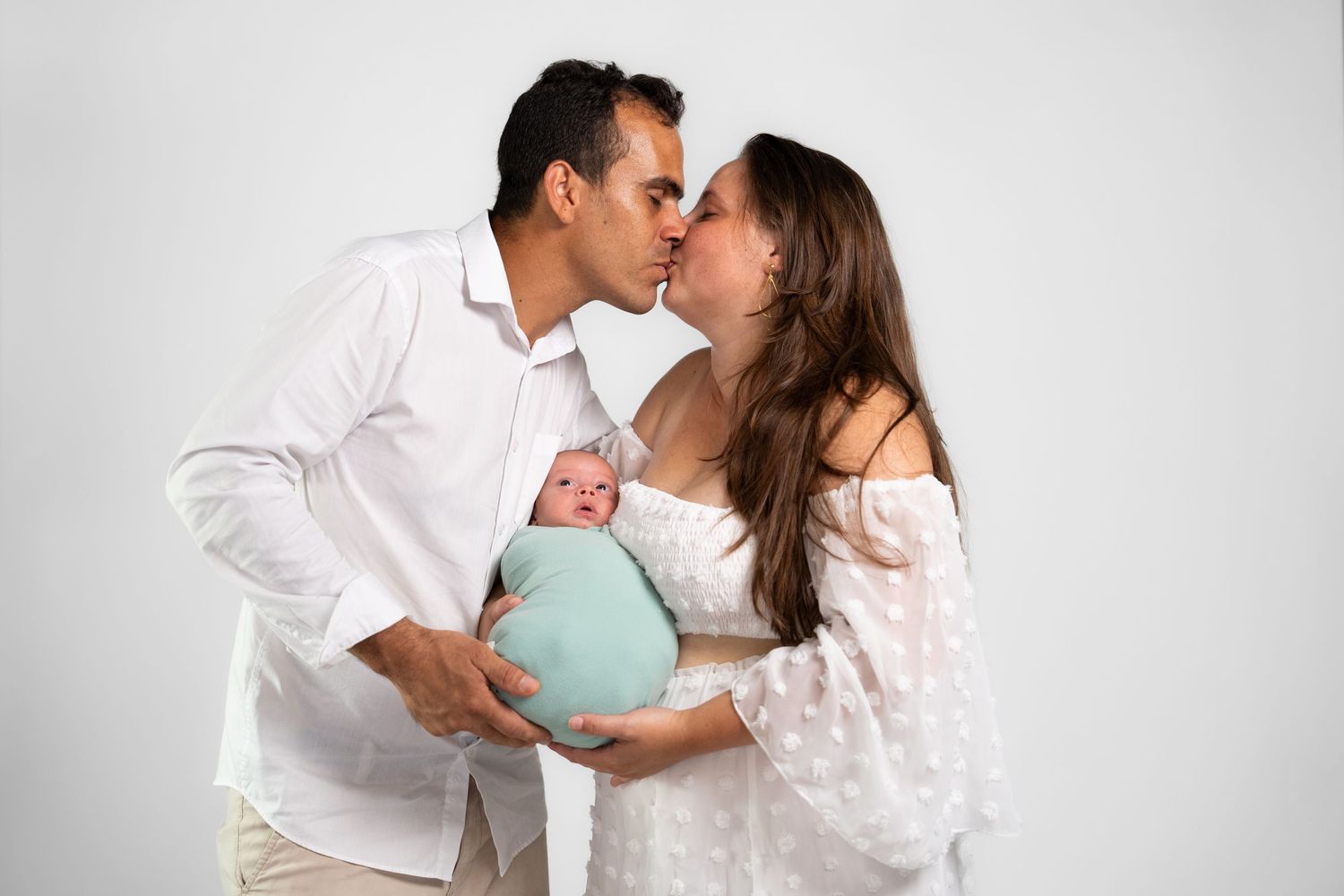 Intimate family portrait series with soft white studio backdrop.