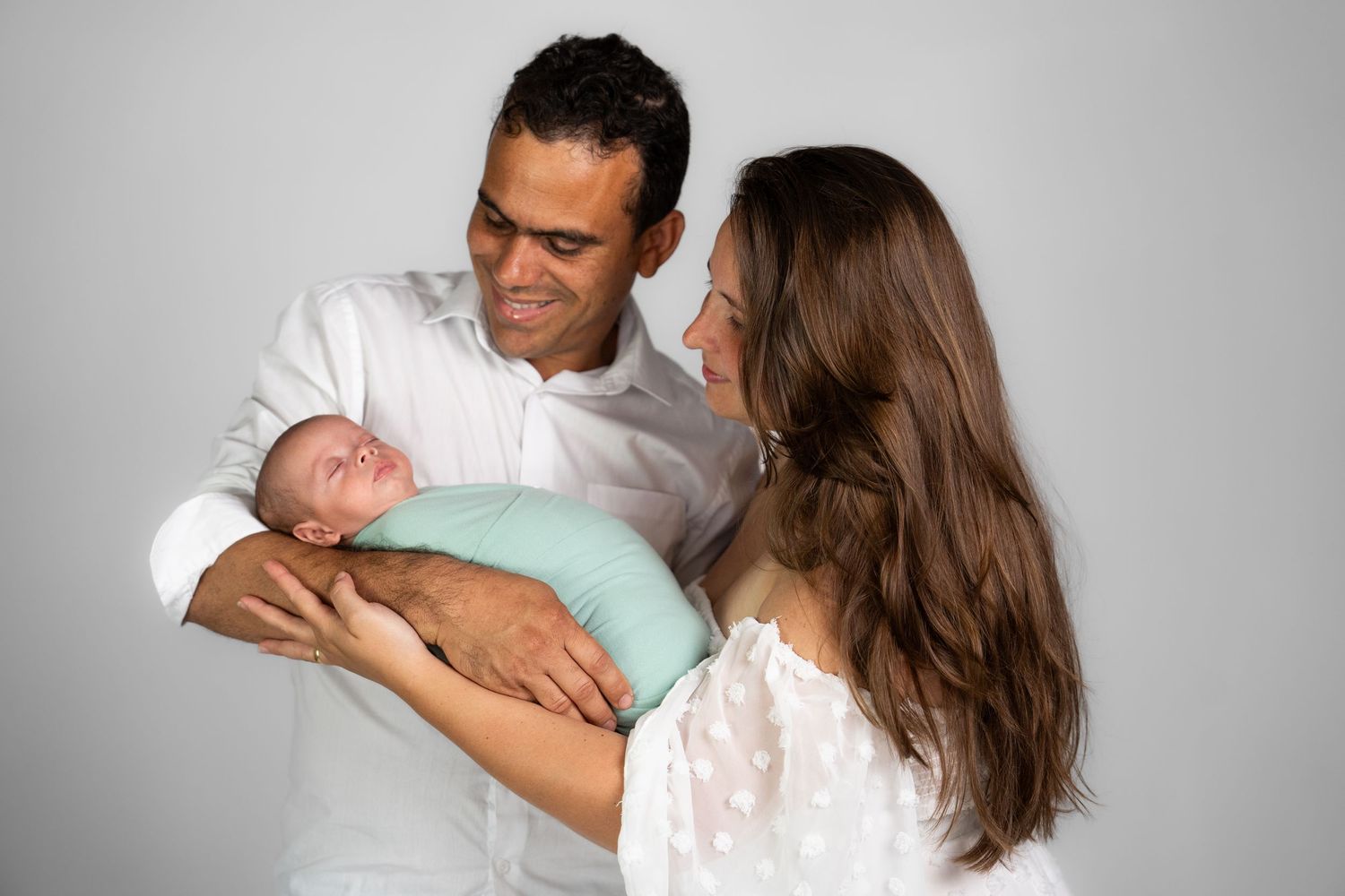 Sweet family moments captured in studio against white background.
