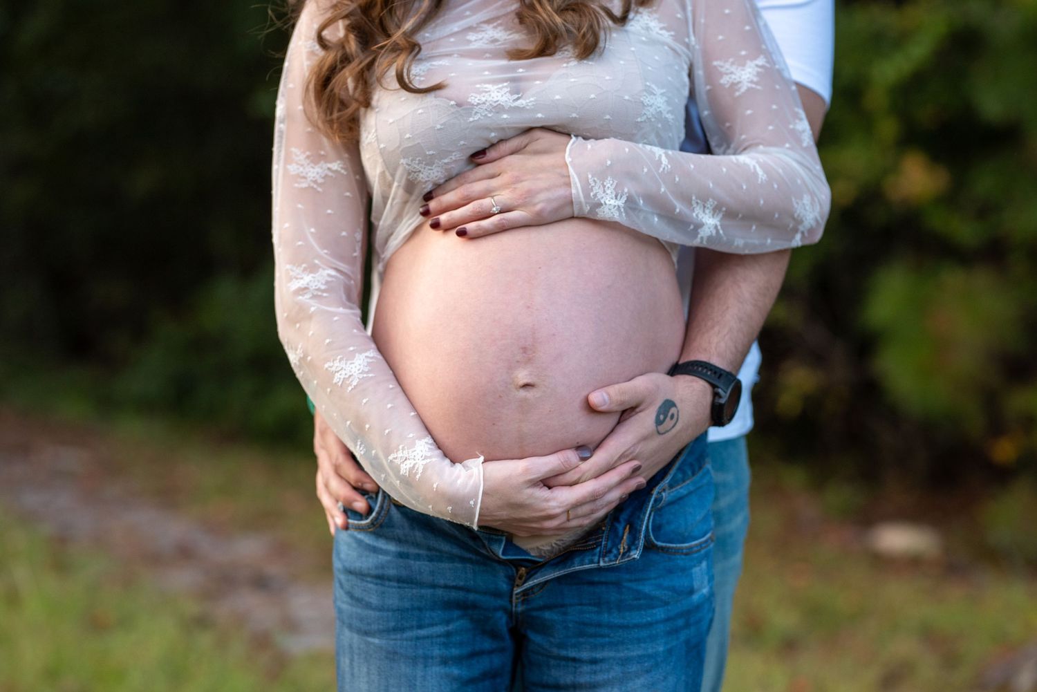 Close-up shots of a pregnant belly in denim jeans against a natural outdoor background.
