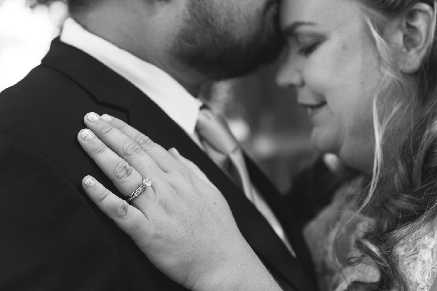 Bride and groom intimate moment with wedding and engagement rings during wedding ceremony