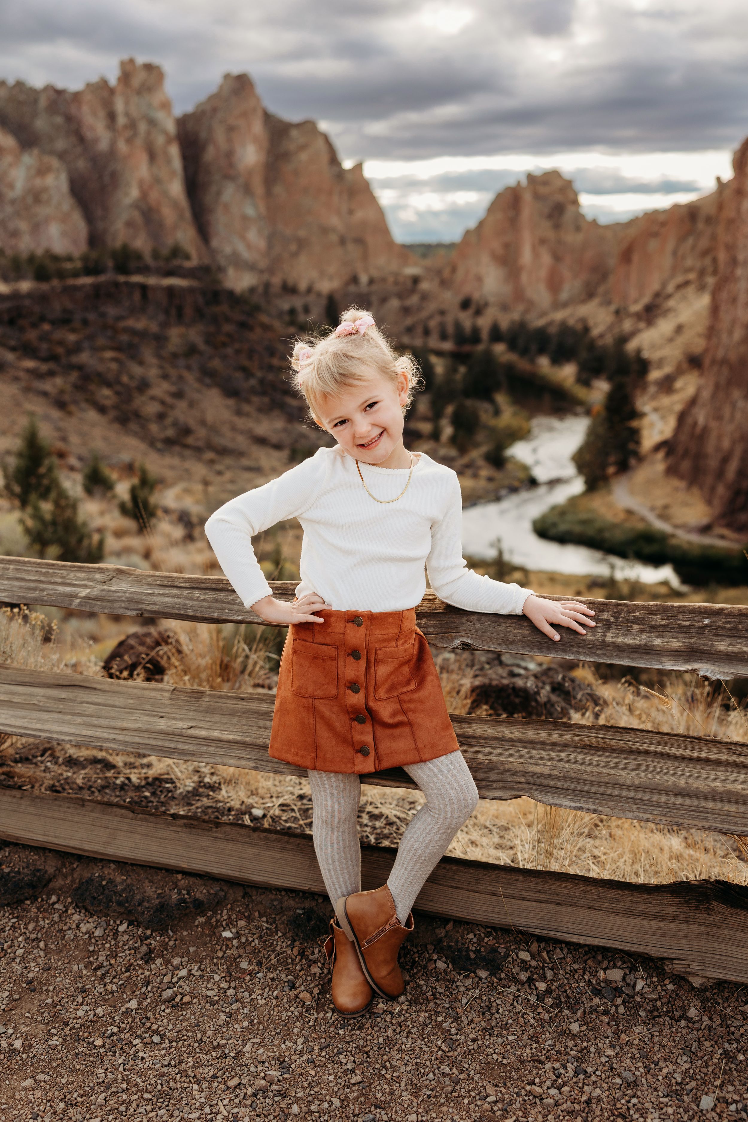 A series of photos showing someone in a white sweater and brown skirt sitting along a scenic canyon overlook on a cloudy day.