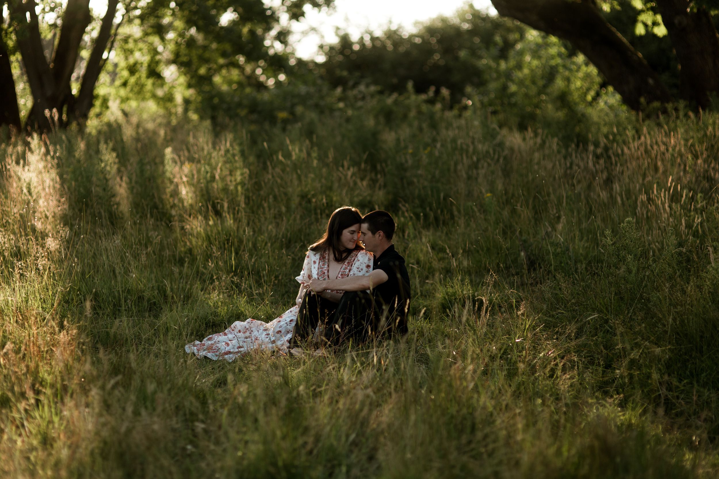 Dreamy golden hour couples portraits taken in tall wild grass meadow. Harrisburg, Oregon engagement photographer. Wedding photographer.