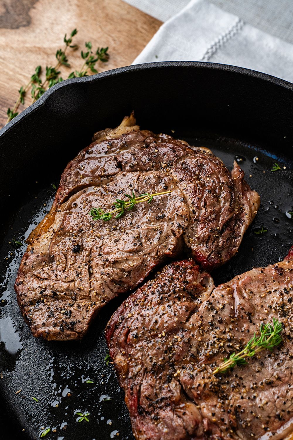 Medium-Rare steak seared in a cast-iron pan for a photoshoot.