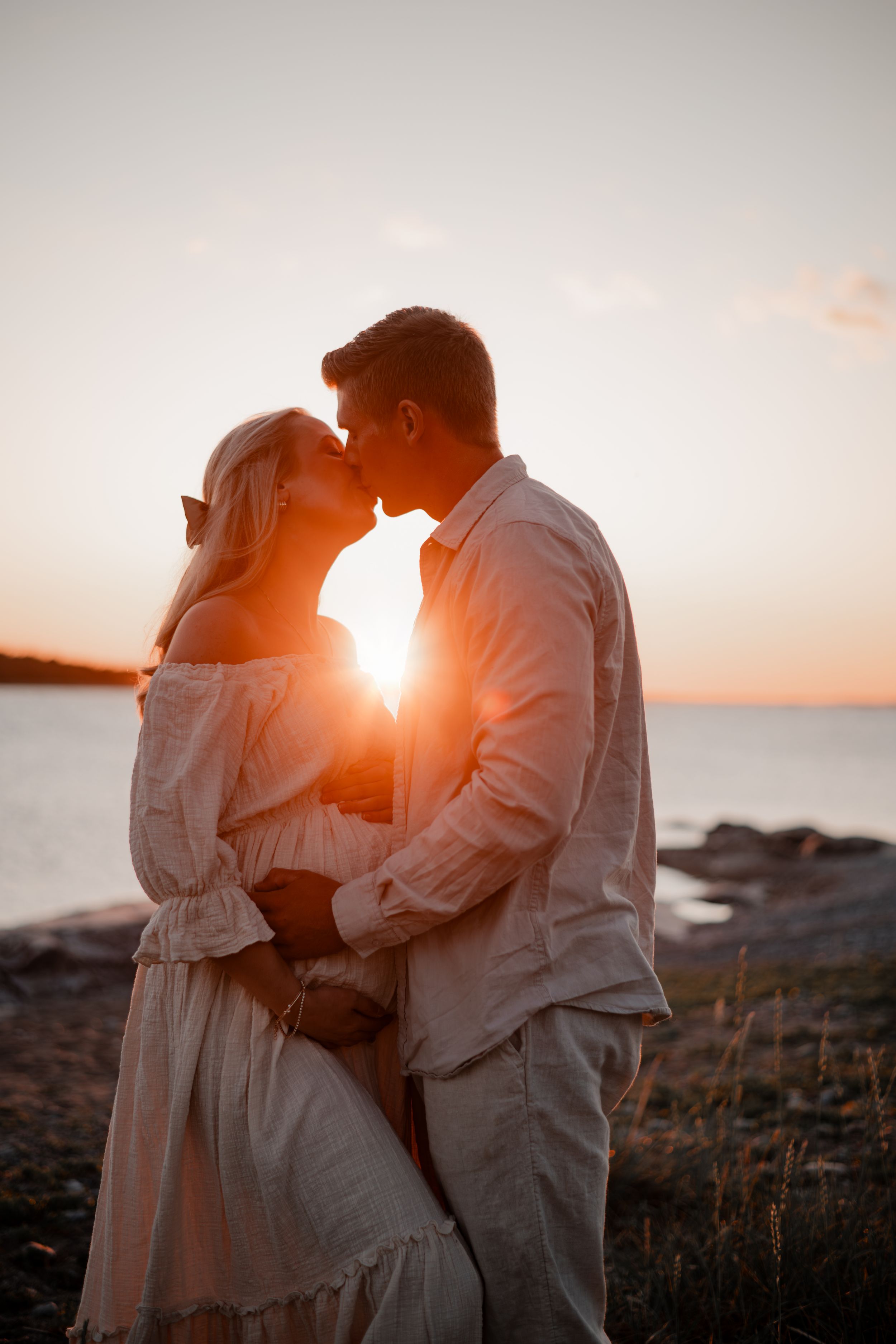 Gravidpar i golden hour på en strand i Nynäshamn