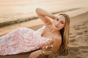 Michigan beach senior portraits. South Haven. Senior laying on beach. Beautiful Sunset.