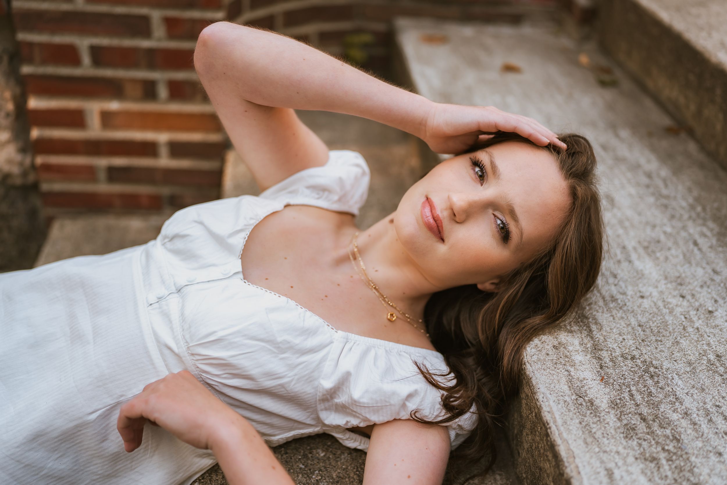 Michigan senior photo shoot. Gull lake. Laying on stairs. Unique pose.