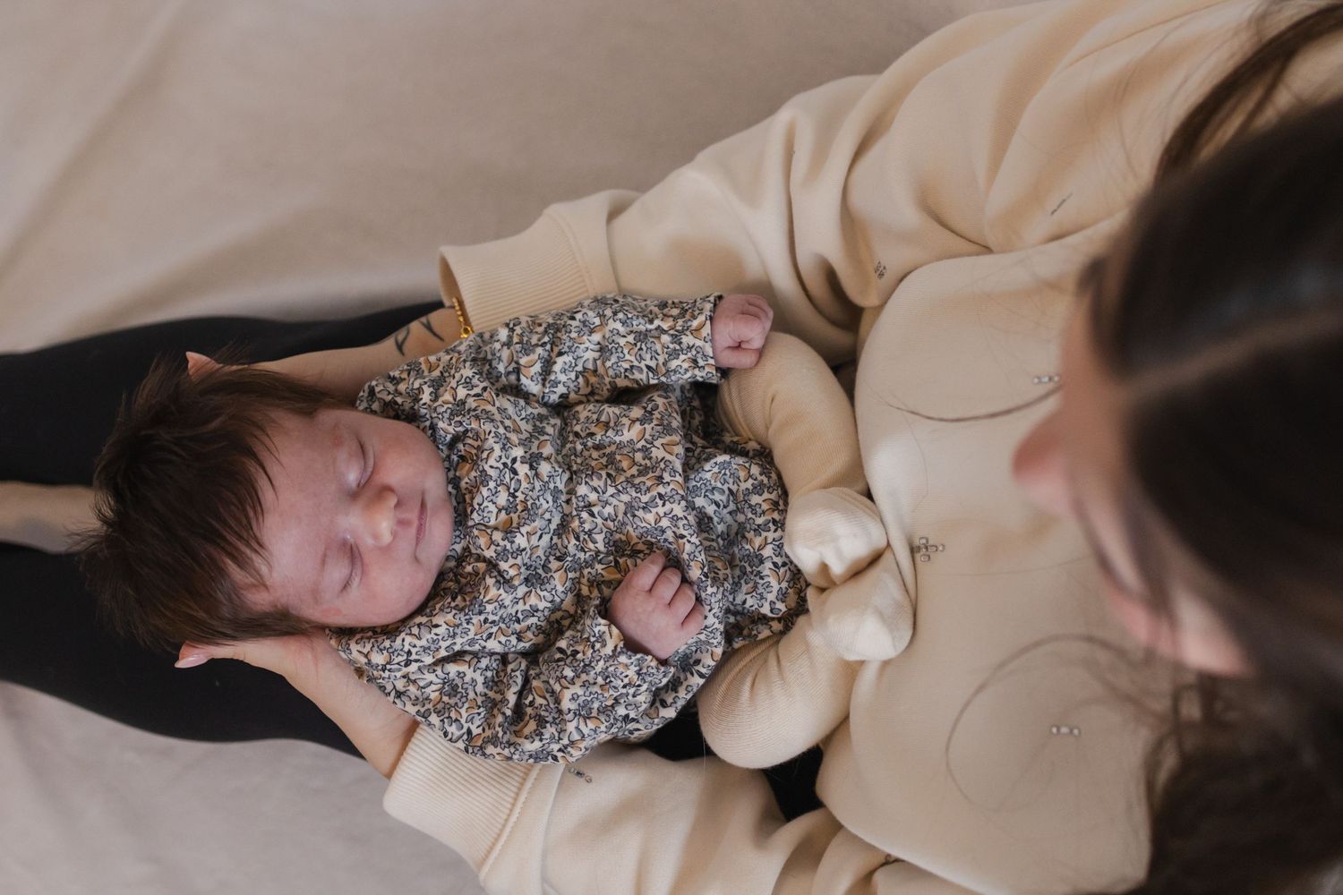 Family shares tender moment together in nursery with crib.