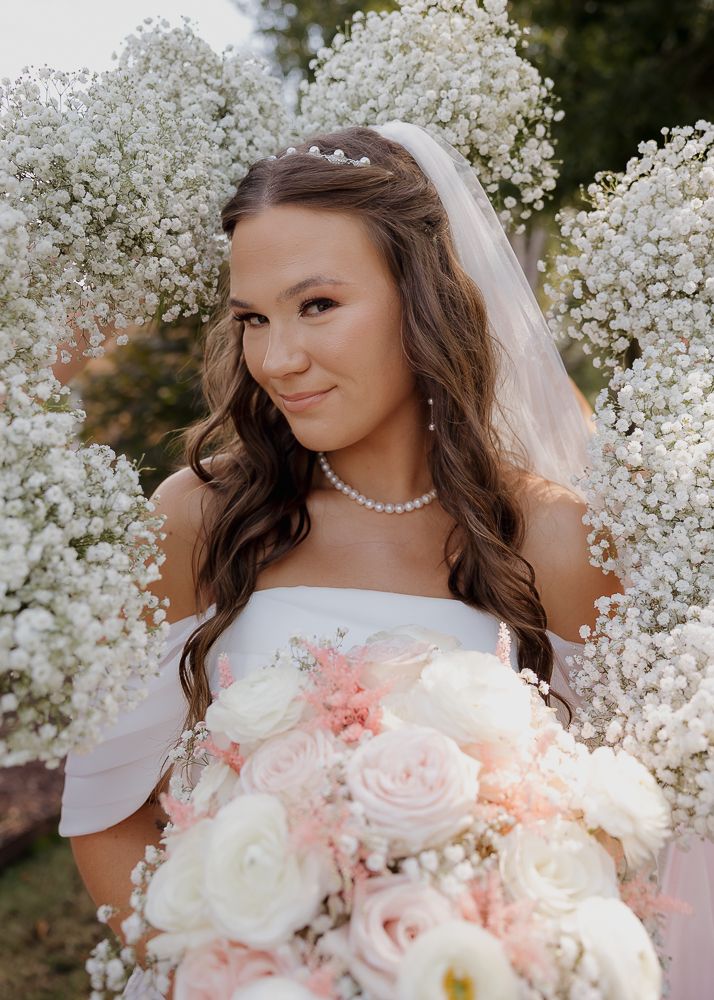 Romantic bridal portrait with baby's breath flowers and soft pink roses.