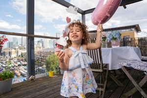 Family enjoying homemade popsicle treats on an outdoor patio during a sunny summer day.