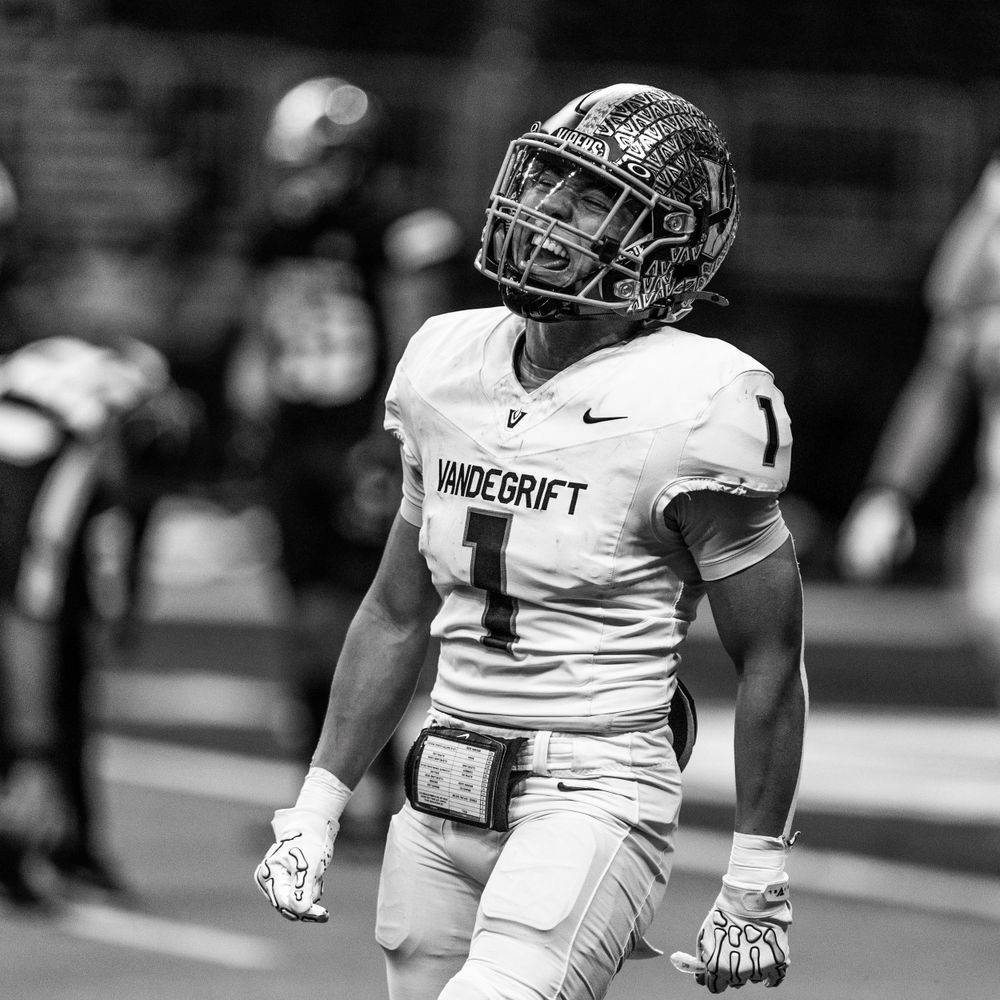 Black and white photo of football player in white Wildcroft jersey on field.