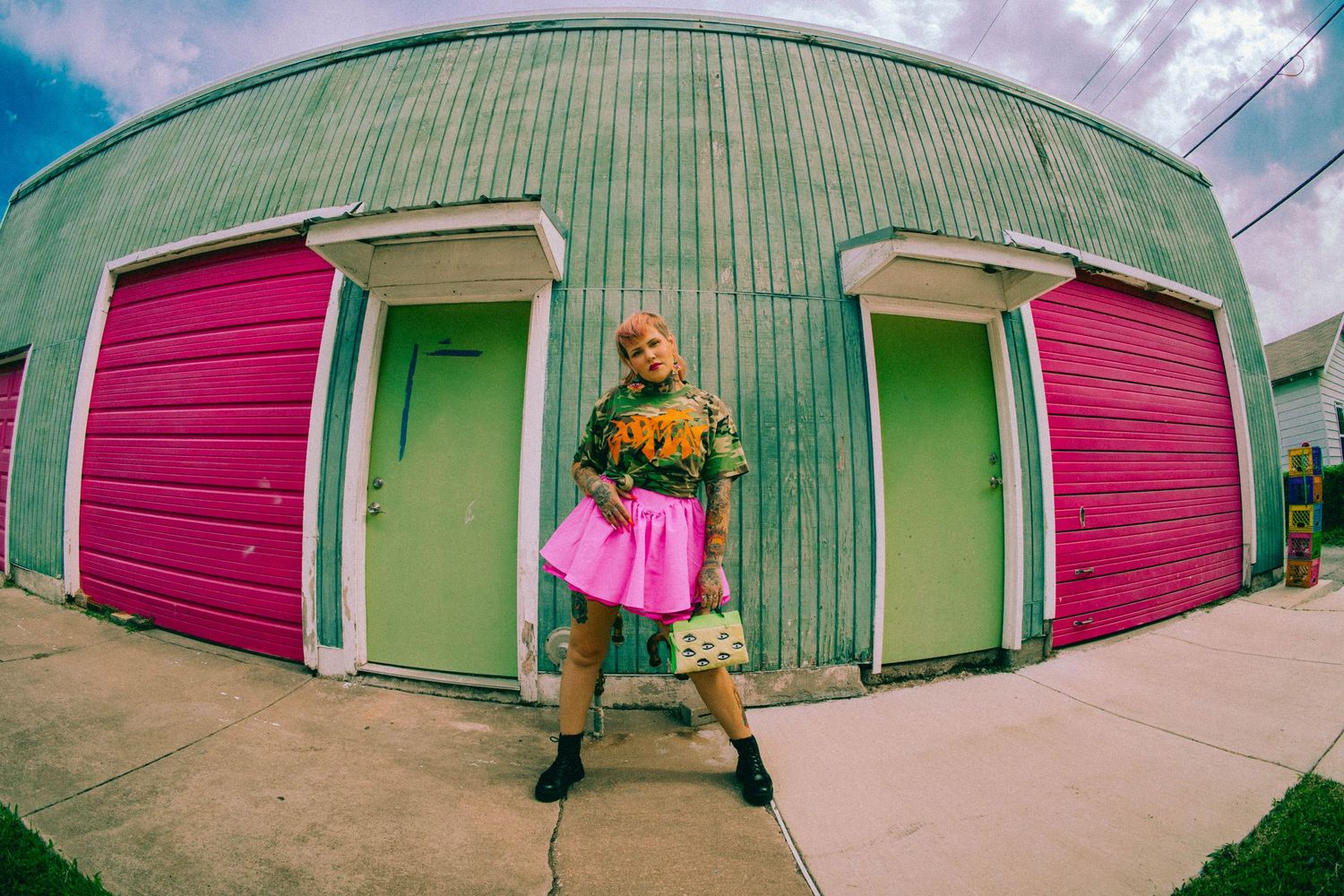 A colorful building exterior with pink and green doors creating a vibrant urban scene.