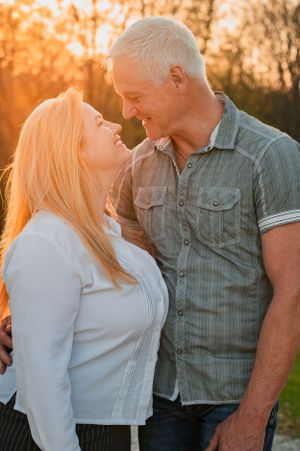 Romantic couple sharing a tender moment in warm sunset lighting.