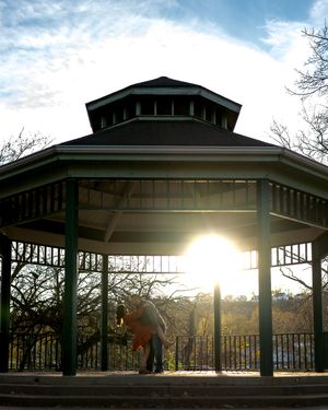 A panoramic series of four photos showing a covered gazebo at sunset with sunlight streaming through its pillars.