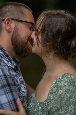 Intimate close-up of couple sharing a tender moment outdoors.