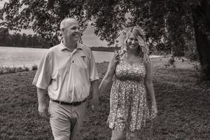 A couple poses together outdoors under trees in a series of candid moments.