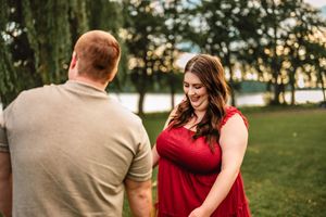 Happy couple sharing romantic moments together in a park setting during golden hour sunset.