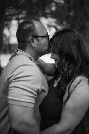 A romantic black and white photo sequence showing a couple sharing a tender kiss.
