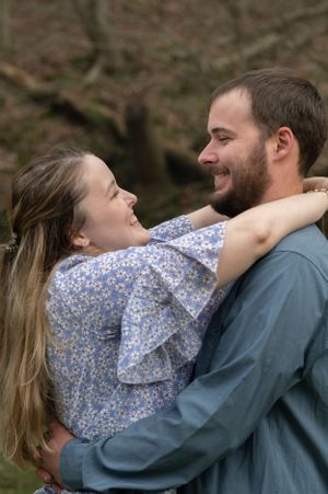 Romantic couple sharing tender moments during outdoor photo session.