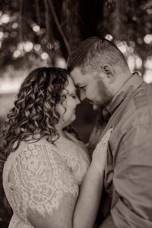 A sequence of black and white photos showing a romantic moment between a couple in formal wedding attire.