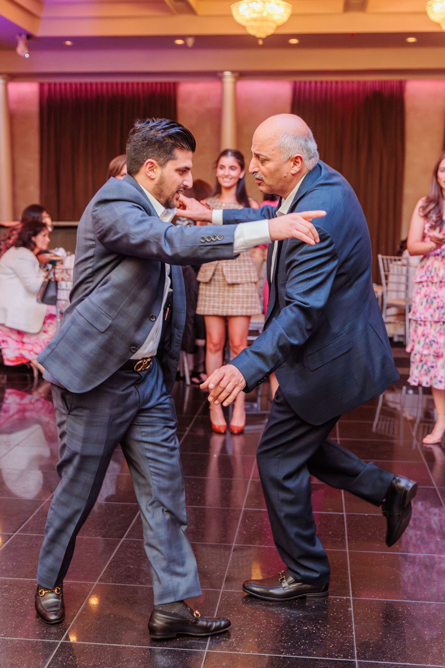 Father and son dancing together at the son's wife's baby shower.