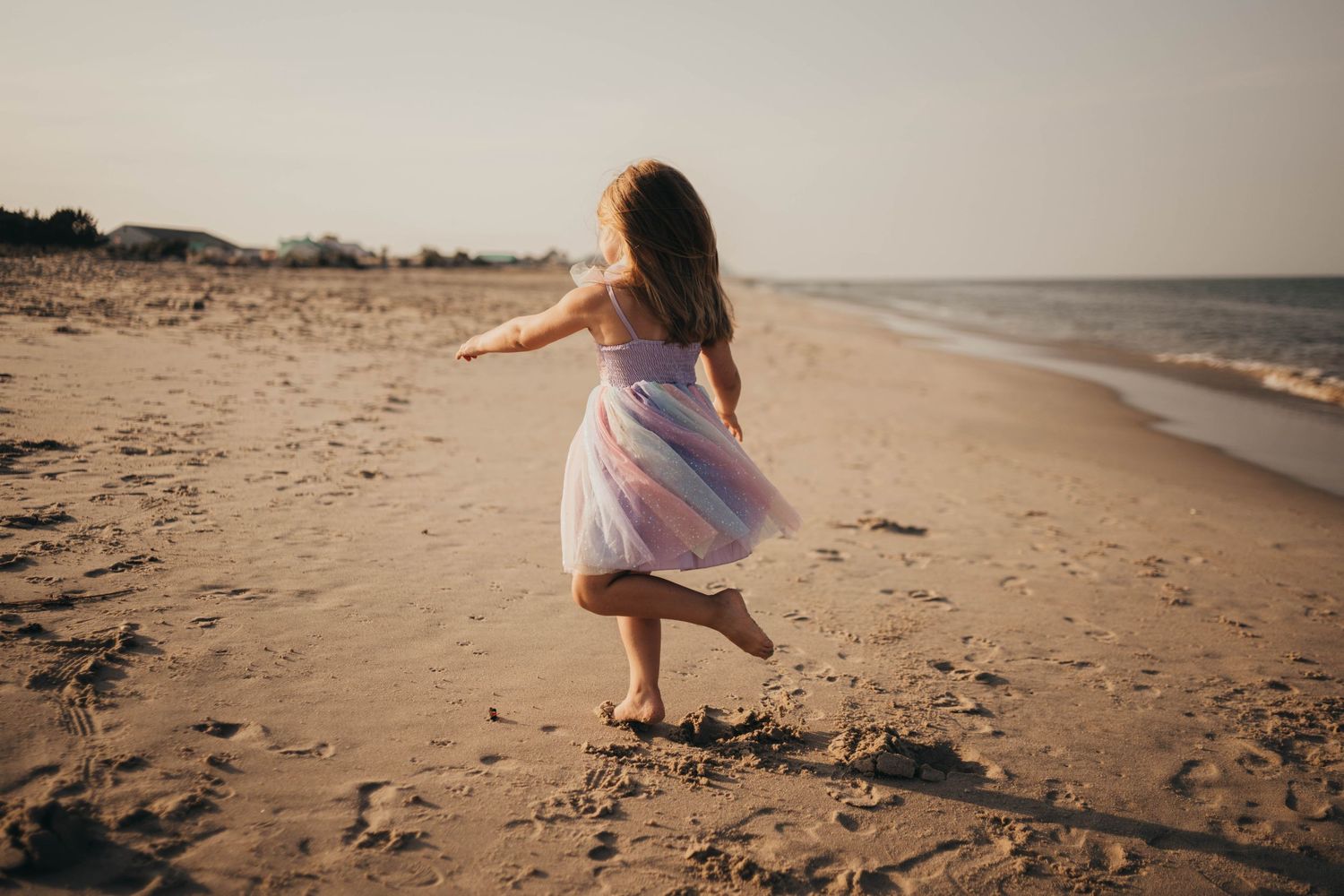Series of dreamy beach photos with people walking along shoreline at golden hour.