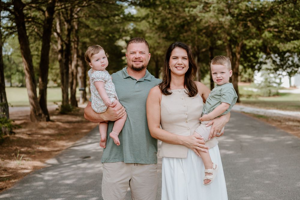 A series of outdoor family portraits taken in a tree-lined path during a sunny afternoon photo session.