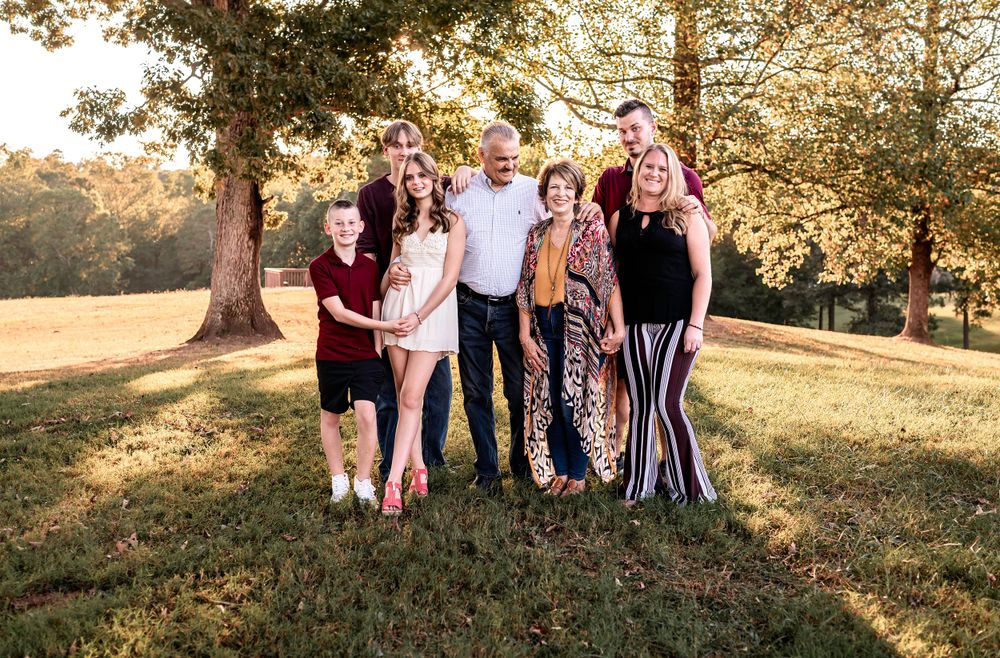 Group outdoor family photo session in a park during golden hour.