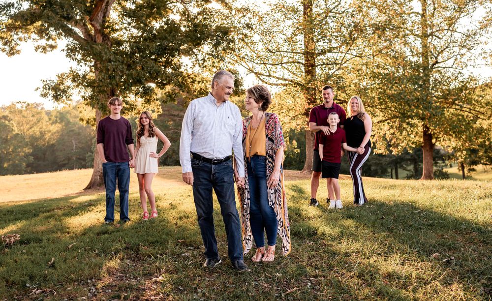 Candid family gathering photographed in warm evening sunlight.