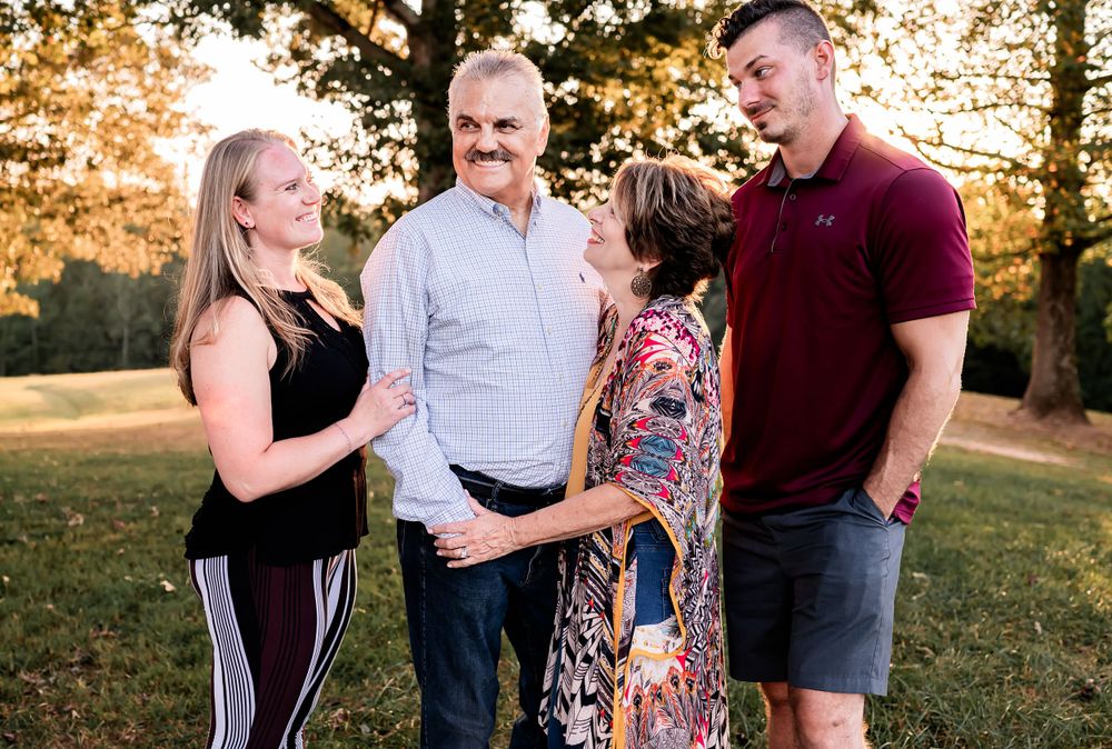 Family discussion captured during outdoor photo session at golden hour.